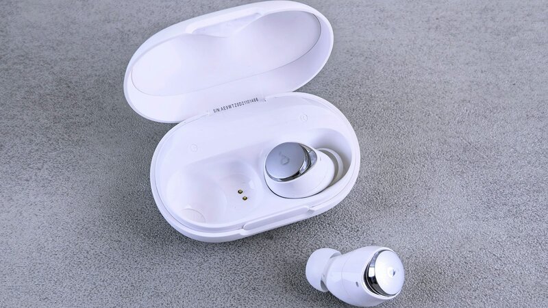 White wireless earbuds with their charging case